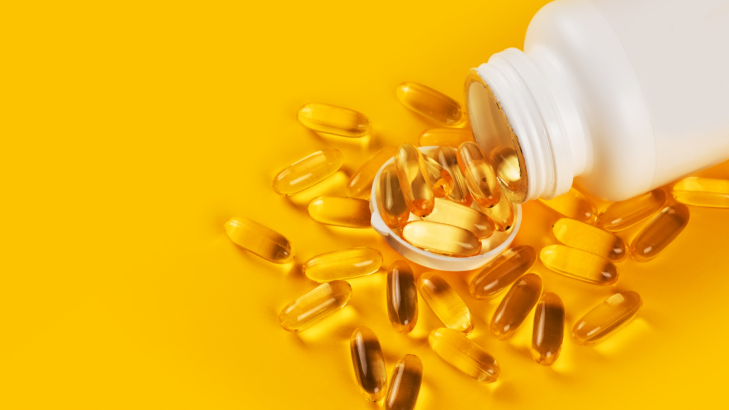 fish oil capsules on yellow background