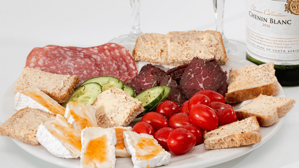 a plate with meat, cheese and bread