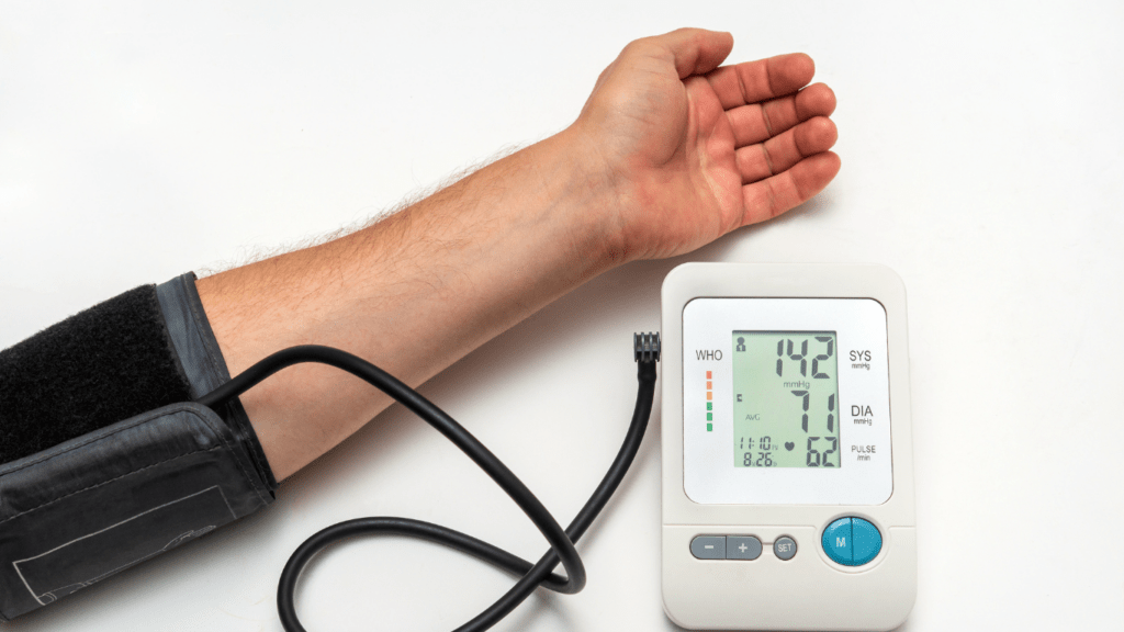 a hand is holding an electronic blood pressure monitor