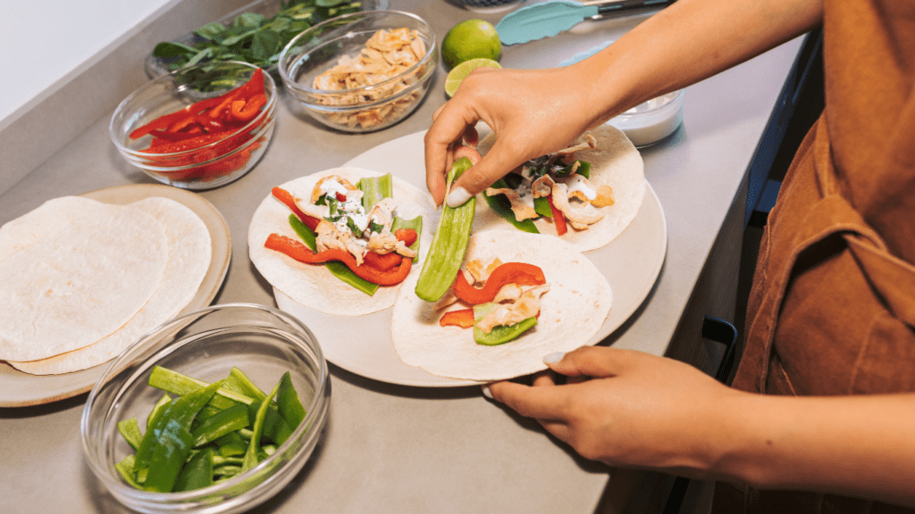 a person in an apron is preparing food on a plate