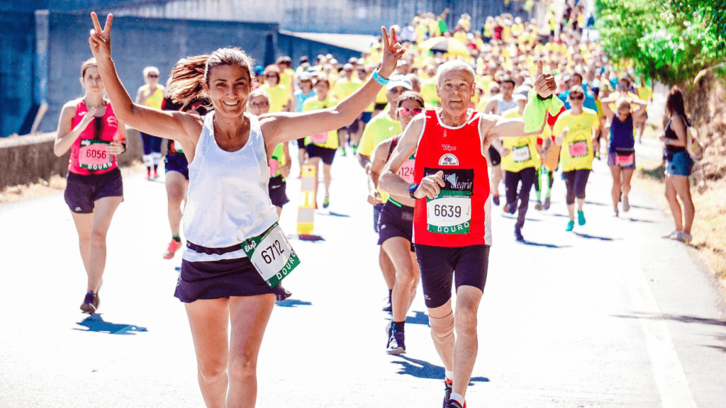 a person running in a marathon with their arms up in the air