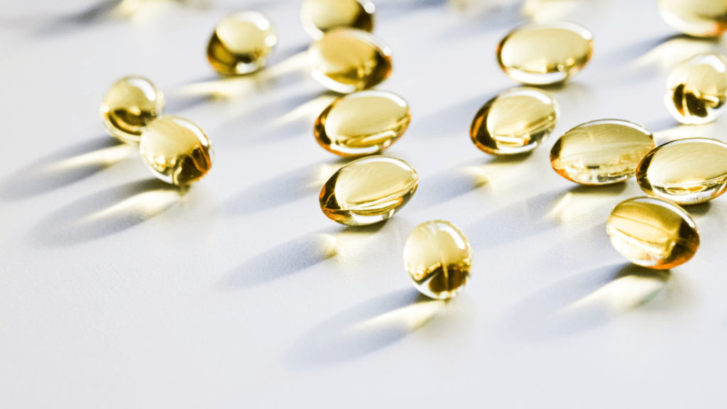 a group of fish oil capsules on a white surface