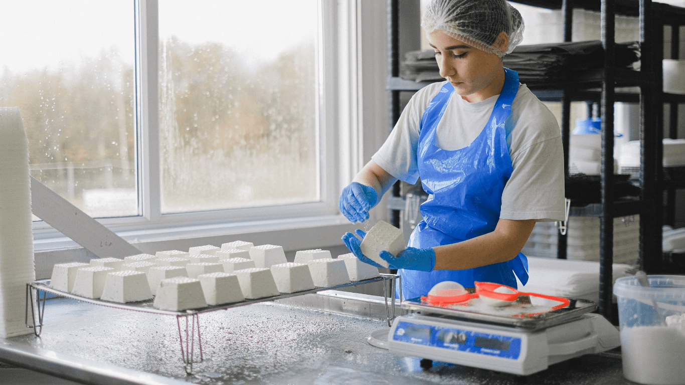 a person in an apron is working in a factory