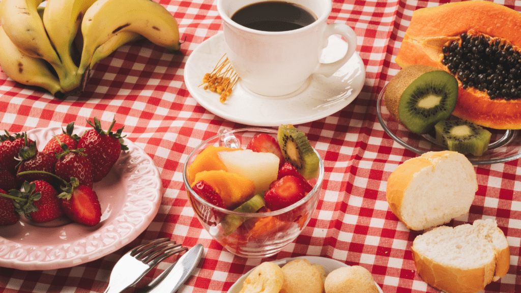 a table with fruit and a cup of coffee