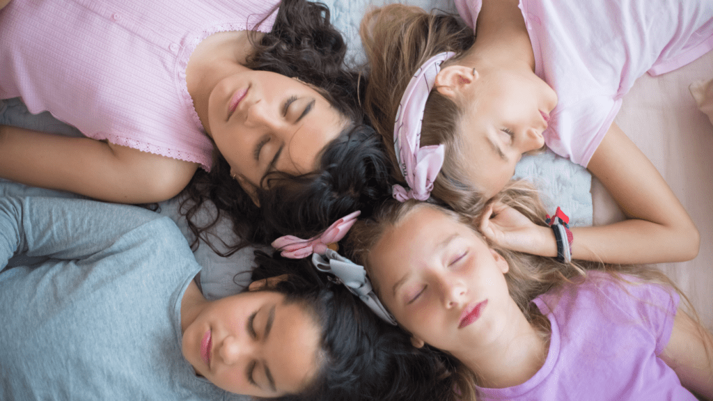 a group of people sleeping on their bed