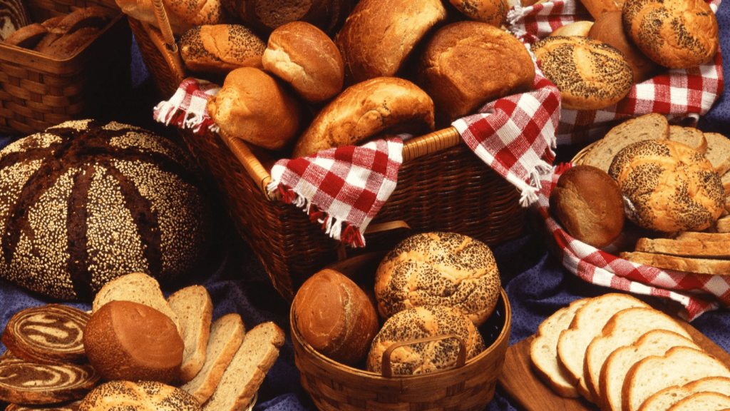 many different types of breads are displayed on a table