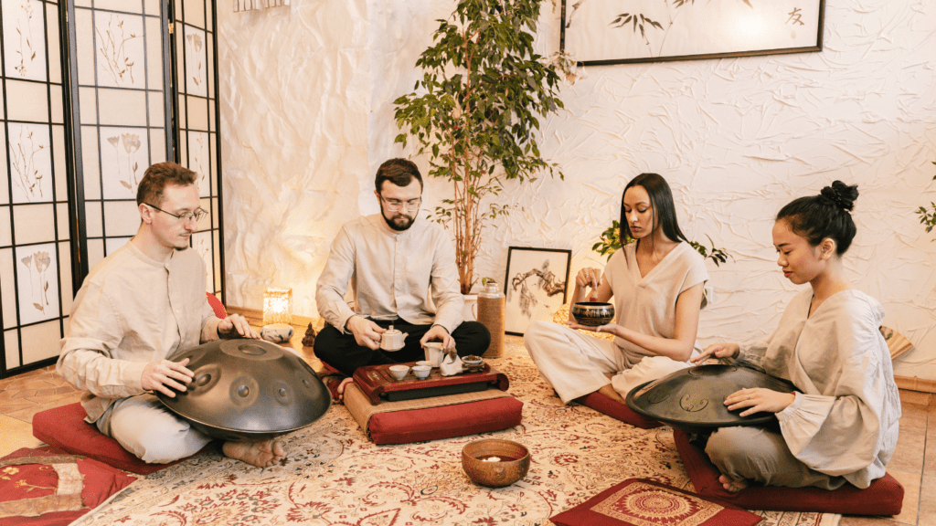 a group of people sitting on the floor playing musical instruments