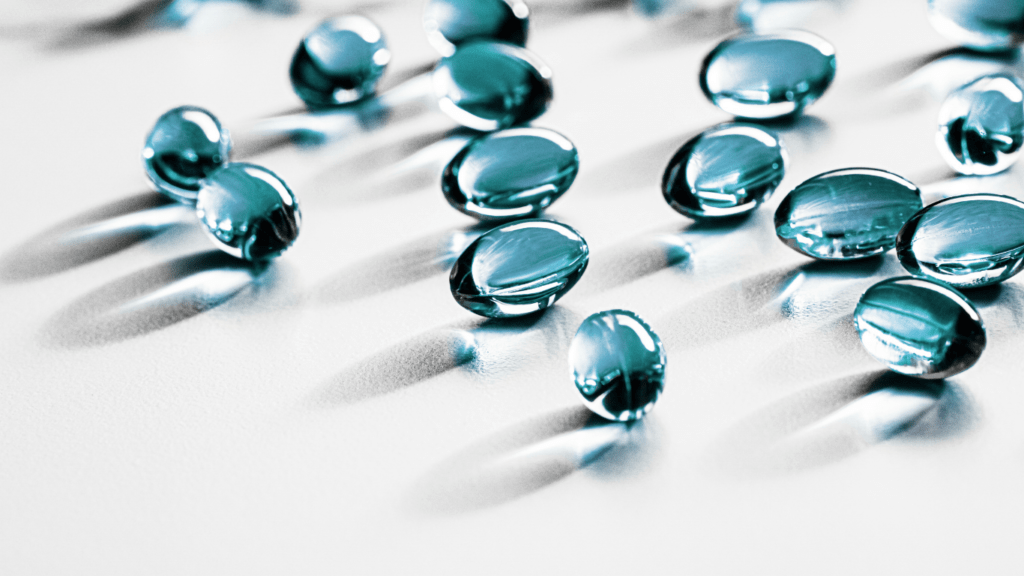 a group of fish oil capsules on a white surface