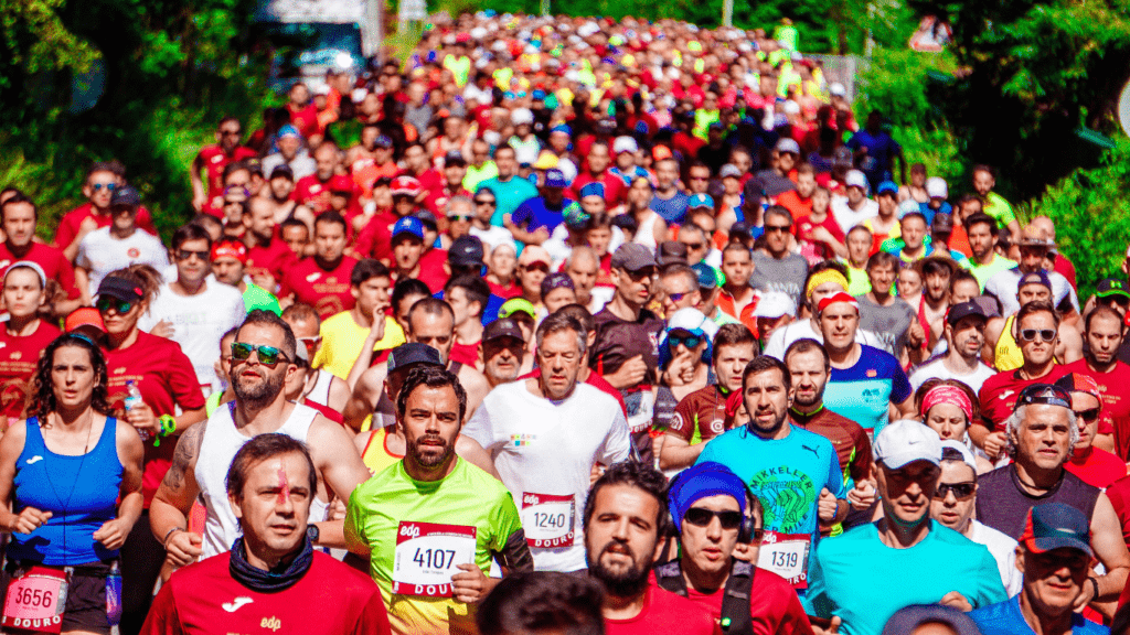 a person running in a marathon with their arms up in the air