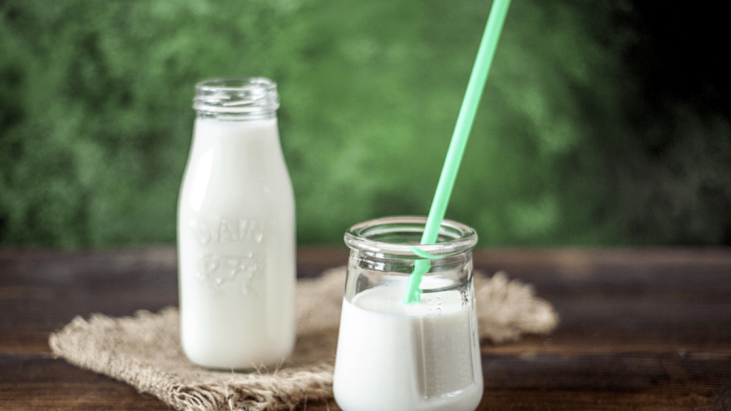 bottles of milk sitting on top of a wooden table