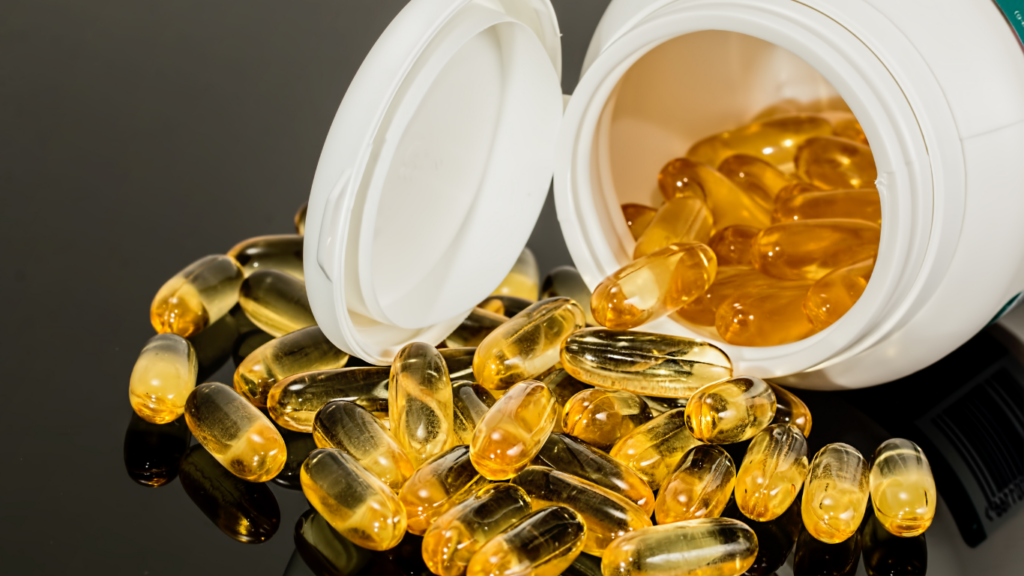 fish oil capsules on yellow background