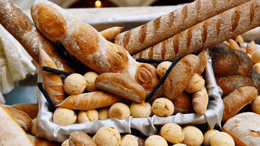 many different types of breads are displayed on a table