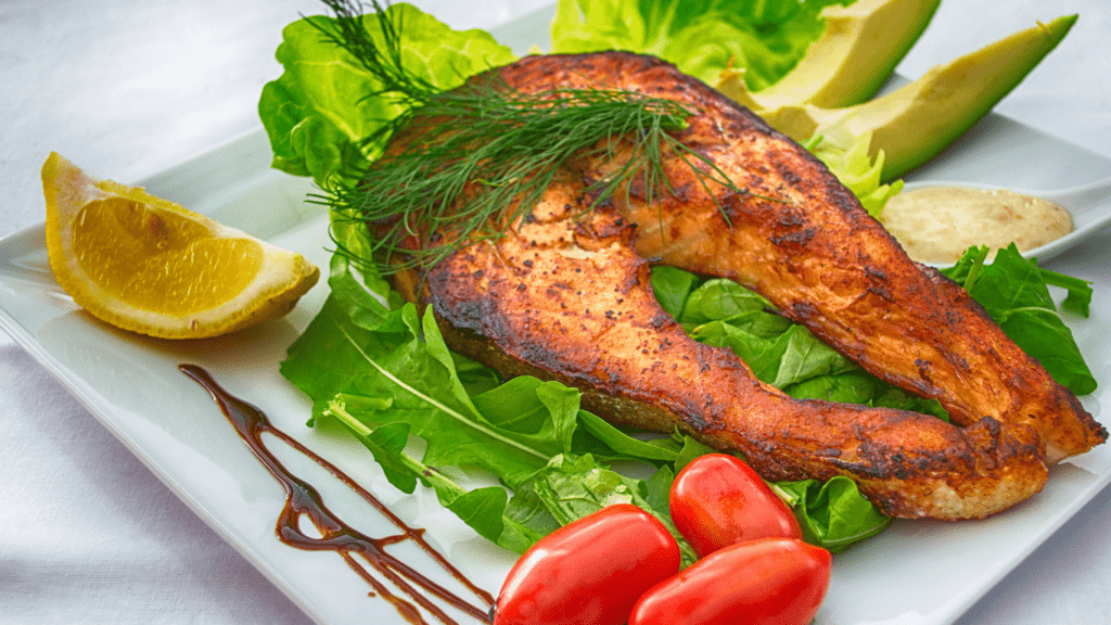 salmon, asparagus and mashed potatoes on a white plate